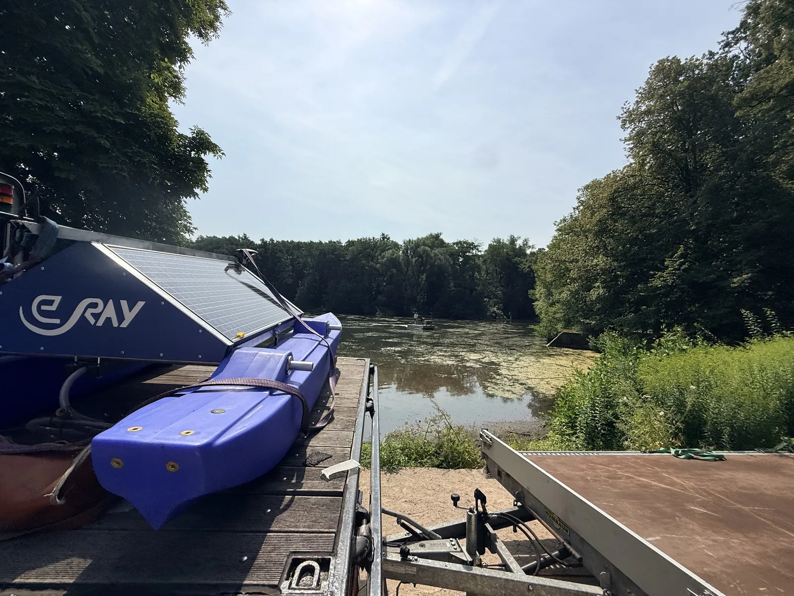 WAMO station on the trailer at the bank, with the water surface in the background